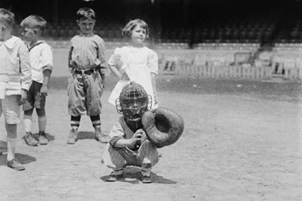 Pint sized Catcher awaits a pitch in Children's Baseball Game