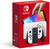 Nintendo Switch OLED (White) in box. Features a 7” OLED display, 64GB storage, and LAN port. Vibrant red packaging with console and Joy-Con