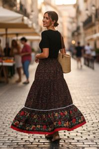 The Women's Folk Long Black Skirt is a stylish and versatile piece perfect for those with a bohemian or gypsy style. Featuring a smocked waist and a floral ruffle hem, this skirt adds a touch of whimsy and charm to any outfit. The long length and peasant style make it a comfortable and easy-to-wear option, while the vibrant floral pattern adds a pop of color to your look. Ideal for women who love to express their unique and creative style, this skirt is sure to become a staple piece in any wardrobe!