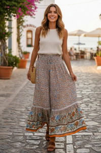 The Women's Folk Long Beige Skirt is a stylish and versatile piece perfect for those with a bohemian or gypsy style. Featuring a smocked waist and a floral ruffle hem, this skirt adds a touch of whimsy and charm to any outfit. The long length and peasant style make it a comfortable and easy-to-wear option, while the vibrant floral pattern adds a pop of color to your look. Ideal for women who love to express their unique and creative style, this skirt is sure to become a staple piece in any wardrobe!