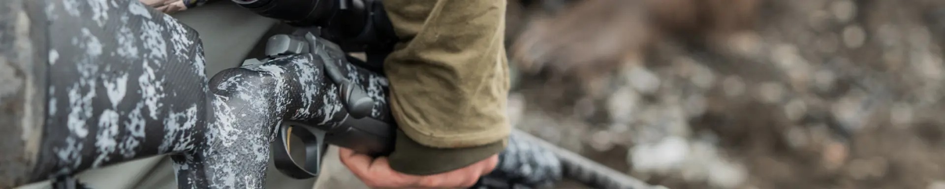 a hunter holding a browning bolt action rifle