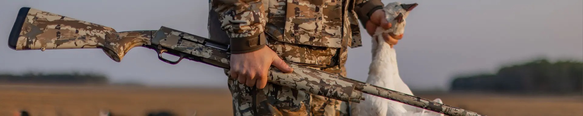a hunter holding browning a5 semi auto shotgun