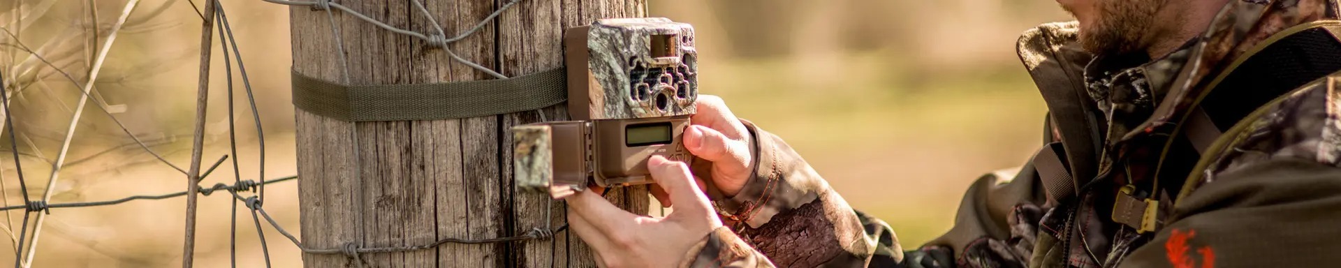a hunter checking a browning trail camera