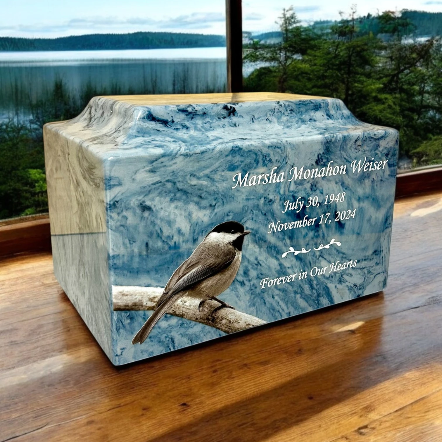 Personalized blue cremation urn featuring a chickadee and a memorial inscription