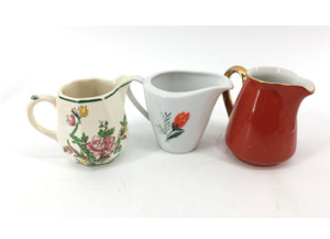 Set of three miniature vintage creamer pitchers. Set of three miniature vintage creamer pitchers.