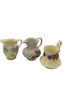 Set of 3 Vintage Miniature Creamer Pitchers with a Floral Pattern. Set of 3 Vintage Miniature Creamer Pitchers with a Floral Pattern.