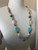 Turquoise on each side with a green, round Tree Agate.
