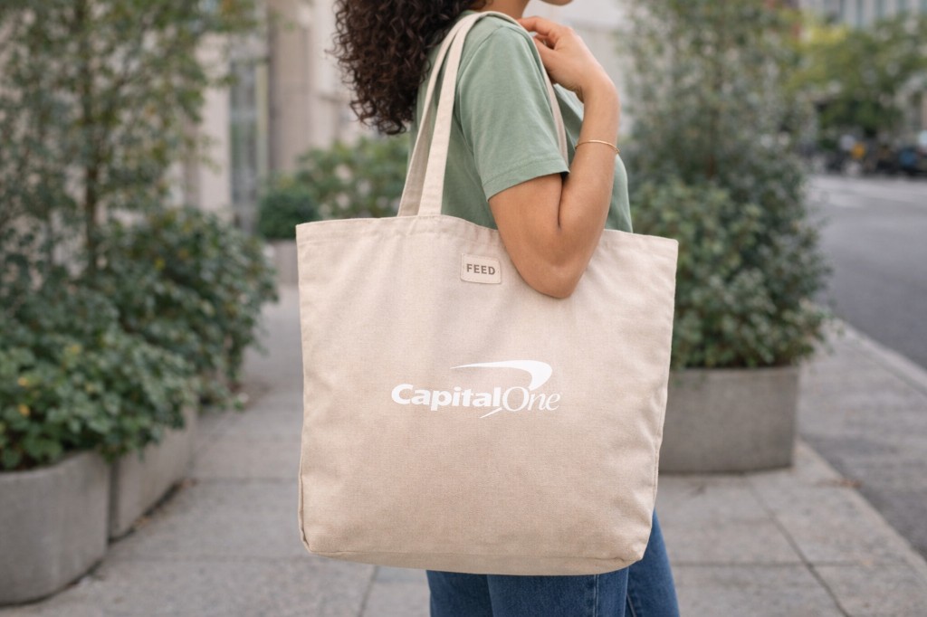 Person carrying a Capital One FEED tote bag