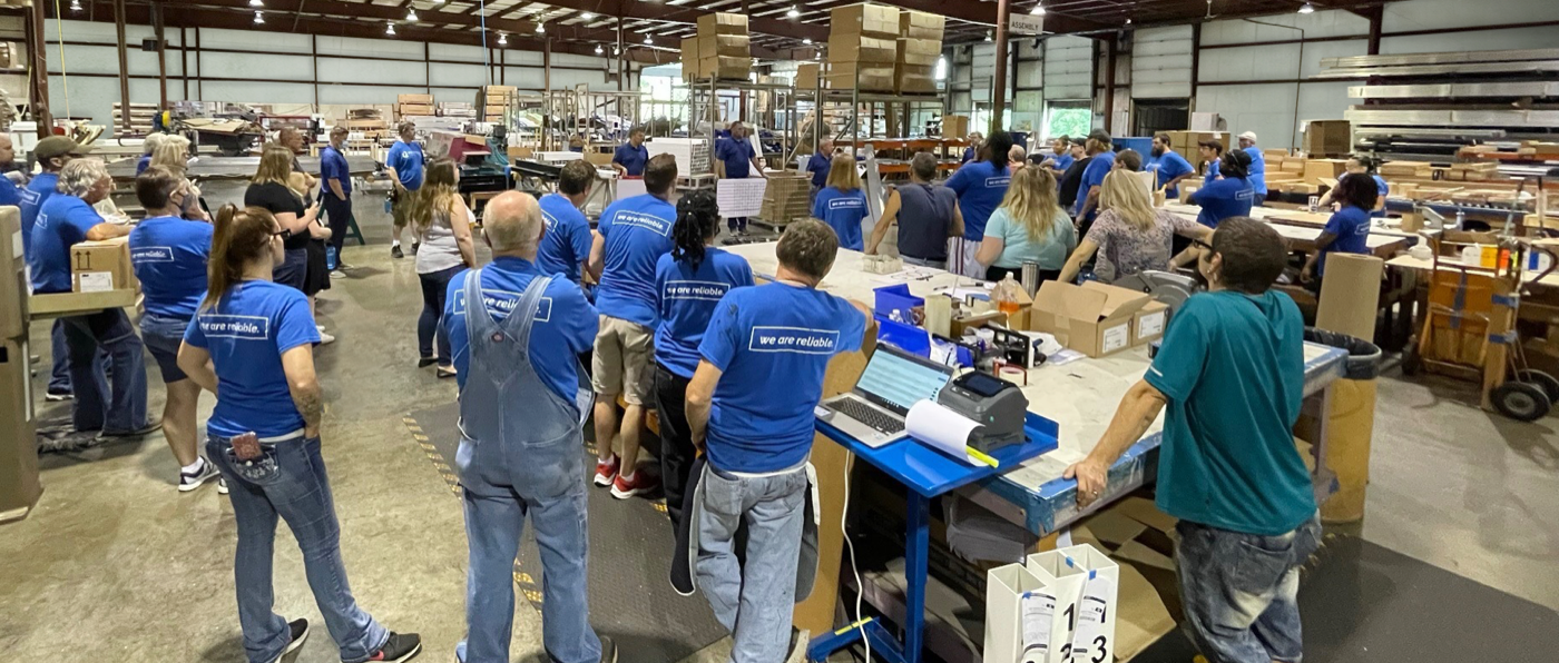 Proveli team — warehouse all-hands meeting