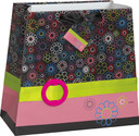 Polka dot gift bag with colorful ribbon accent and gift tag.