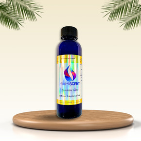 Elegant Sunshine Glow Diffuser Oil on Display
A sleek blue bottle of Miami Scent Sunshine Glow Diffuser Fragrance Oil sits gracefully on a wooden platform, framed by tropical palm leaves. The warm, neutral background enhances the luxurious and refreshing vibe of the premium scent