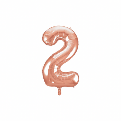 Metallic numeral two balloon in rose gold for party setup