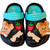 Toddler slip-on beach clogs in bold midnight black featuring contrast aqua blue pivoting heel straps and colorful 3D charms.