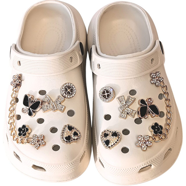 Off-White Butterfly & Heart Charm Clog – A clean, ivory classic elevated by luxurious rhinestone butterflies and golden hardware.