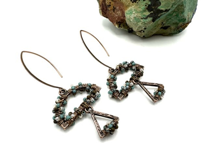 Step 1

Watch the video above or on our YouTube channel for a tutorial on how to make these earrings from Guest Designer Deb Floros!

List of Components
Note: Please make sure to double check our list of components with what's actually in stock on the supplies tab. We've also added alternate supply codes to try if the original ones are not in stock.

  Artistic Wire, Copper Craft Wire 24 Gauge Thick, Antiqued Brass (20 Yard Spool) (WCR-4201, pieces: 1, packages: 1)
Ear Wire, V-Style 33mm, Antiqued Copper, by Nunn Design (1 Pair) (FEA-129, pieces: 1, packages: 1)
Exclusive Designer Palette, Toho Seed Bead Mix, Round 11/0, Ancient Turquoise V2, 4 Color Set (JK-0088, pieces: 1, packages: 1)
Ergonomic Chain Nose Pliers (TOOL-125, pieces: 2, packages: 2)
Ergonomic Side Cutter - Semi Flush (TOOL-128, pieces: 1, packages: 1)
Nunn Design Antique Copper Hoop Hammered Mini Half Circle Horizontal Single Loop (ND0162, pieces: 2, packages: 2)
Nunn Design Antique Copper Hoop Hammered Mini Triangle Horizontal Single Loop (ND0158, pieces: 2, packages: 2)
