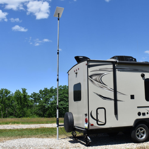 Photo of the TowerLink™ pole installed to the back of a parked RV with a Starlink at the top