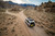 Photo of van with Starlink on roof driving down a remote dirt road, coming to a fork in the road with mountains in the background Photo of van with Starlink on roof driving down a remote dirt road, coming to a fork in the road with mountains in the background