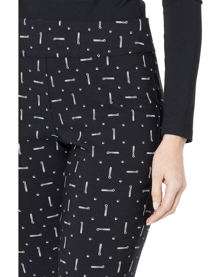 Close up view of the black golf print, small white golf clubs on top of a black background