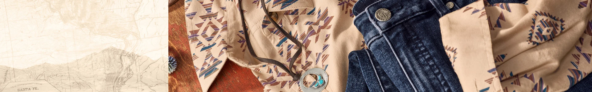 Western-inspired patterned shirt and dark denim jeans arranged together, featuring geometric prints in neutral and blue tones.