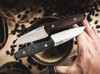 Boker Daily Knives AK1 Fixed Blade Knife - 3.11" RWL-34 Satin Reverse Tanto, Carbon Fiber Handles, Black Leather Sheath - 124502