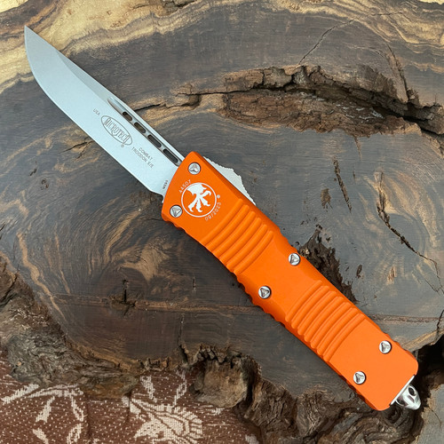 Microtech 143-10OR Combat Troodon AUTO OTF Knife - 3.75" Stonewashed Drop Point Plain Blade, Orange Aluminum Handle Microtech 143-10OR Combat Troodon AUTO OTF Knife - 3.75" Stonewashed Drop Point Plain Blade, Orange Aluminum Handle