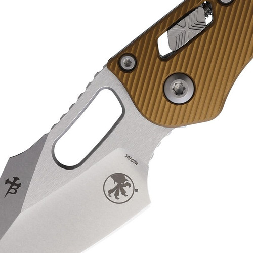 Microtech 169RL-10FLTA Stitch Folding Knife - 3.75" Bohler M390MK Stonewashed Spear Point Blade, Tan Aluminum Handles, RAM-Lock Microtech 169RL-10FLTA Stitch Folding Knife - 3.75" Bohler M390MK Stonewashed Spear Point Blade, Tan Aluminum Handles, RAM-Lock