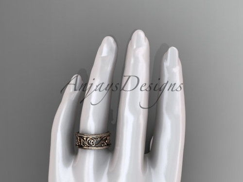 Charming blend of Celtic knots and subtle nature inspired elements on this wedding band in 14k rose gold from Anjays Designs.