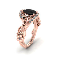 Rose gold Celtic knot engagement ring with a pear cut black diamond center stone