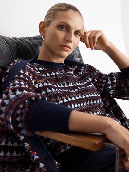 Model wearing metallic knitwear