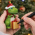 Suki - Personalisable Christmas Decoration - Green Dinosaur with Red Hat