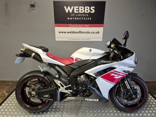 Yamaha YZF R1 motorcycle, sporty white and red sportbike with black accents, displayed at Webbs Motorcycles store.