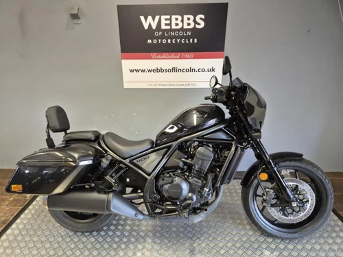 HONDA REBEL 1100 TOUR:13040-2220, black touring motorcycle with windscreen, passenger backrest and hard panniers displayed at Webbs Motorcycles.