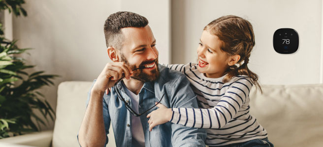 family in a room with smart thermostat