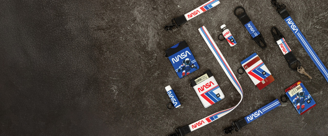 Retro style NASA Thread wallets, keychains, and lanyards on a grey background.
