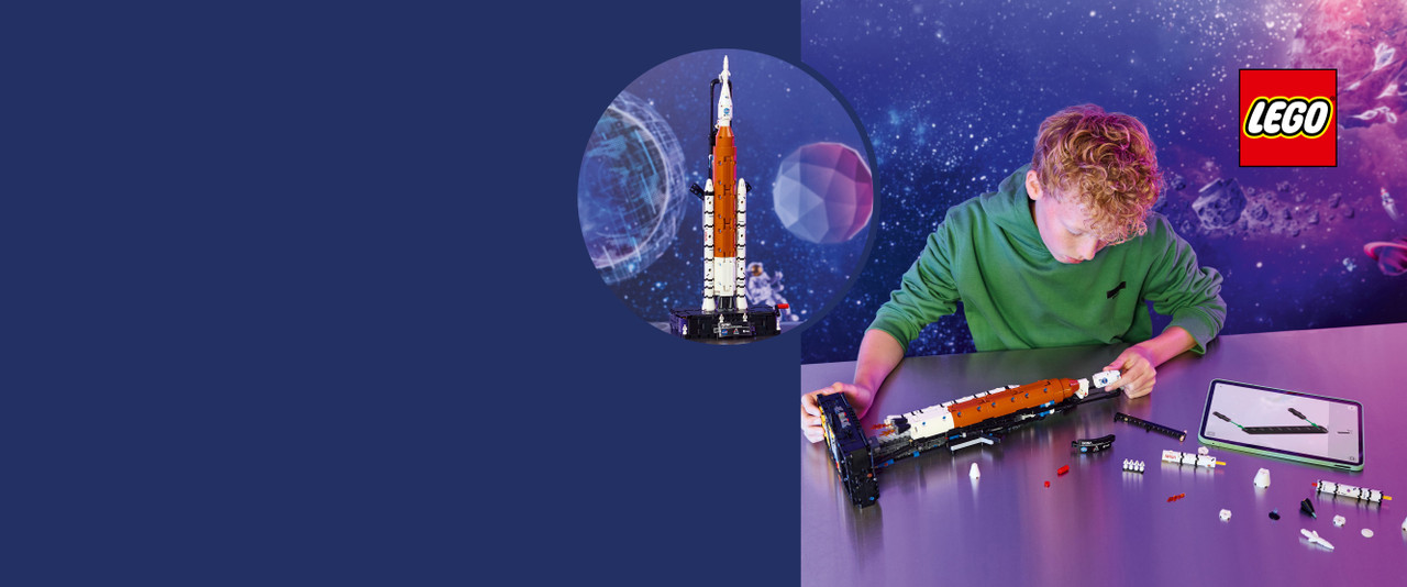 boy in green shirt building the new LEGO artemis rocket
