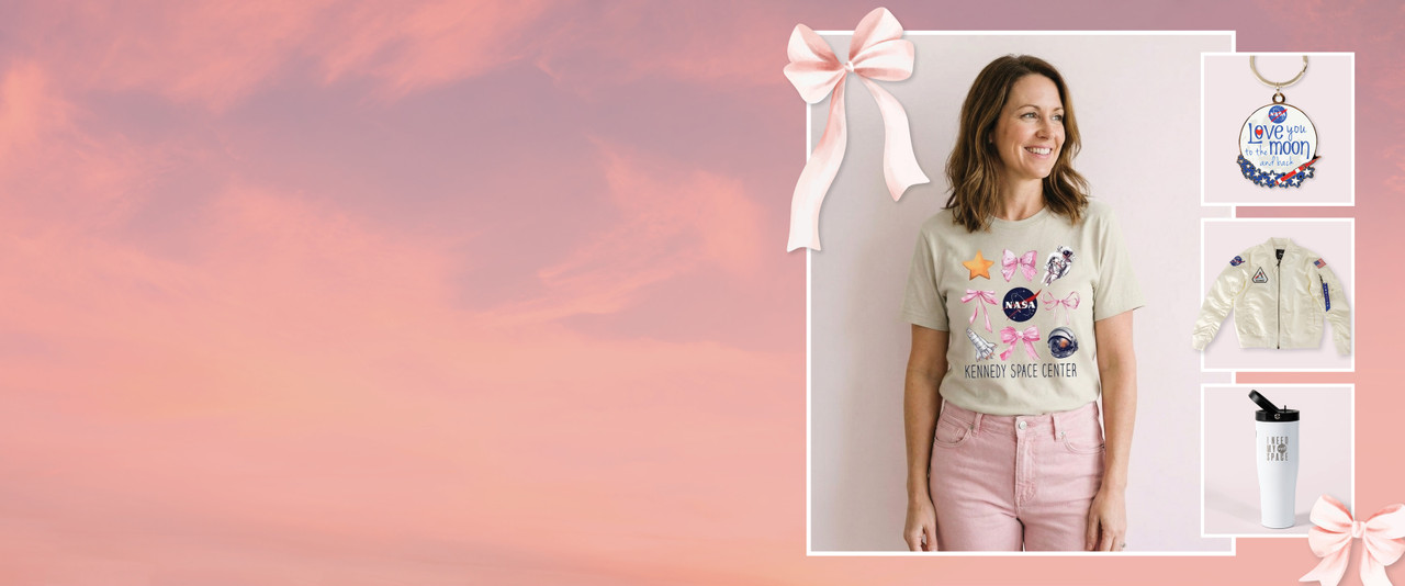 Women in khaki tee, keychain, artemis jacket, and I need my space cup, on pink background with bows.