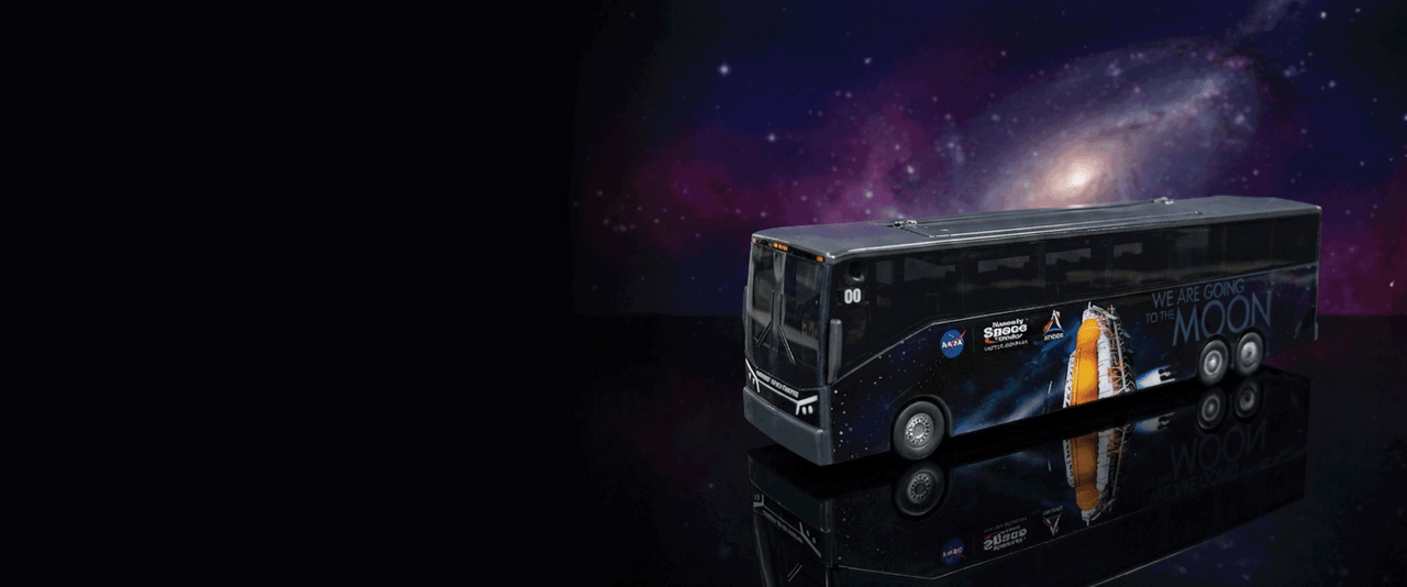Kennedy Space Center Tour Bus Popcorn Bucket with popcorn on a black and purple galaxy background.