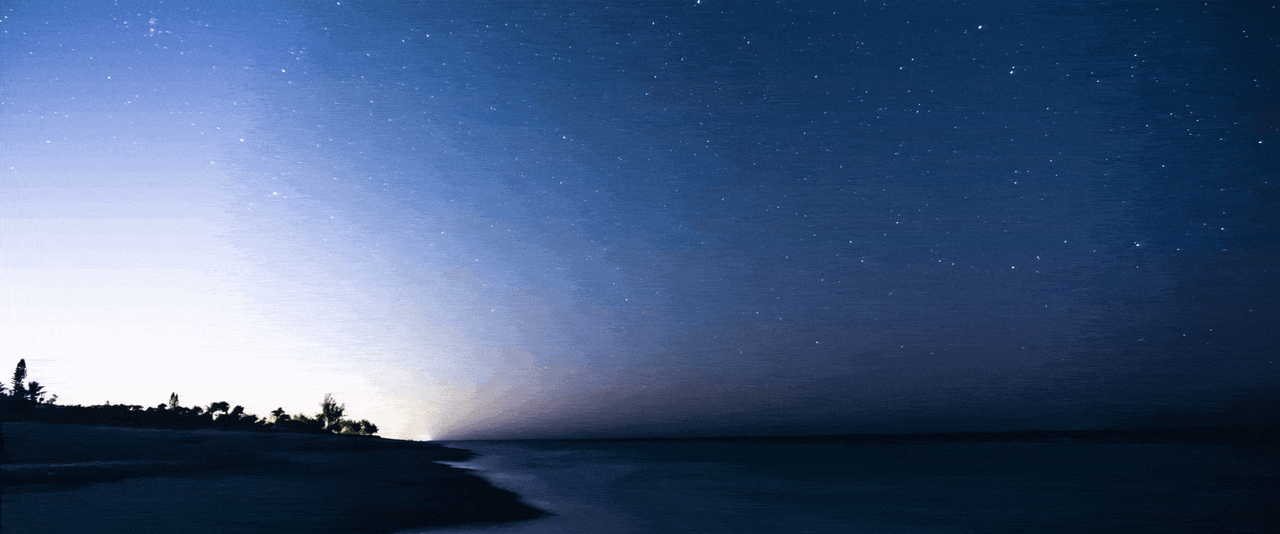 Shooting stars and twinkling stars in a night sky above a body of water.