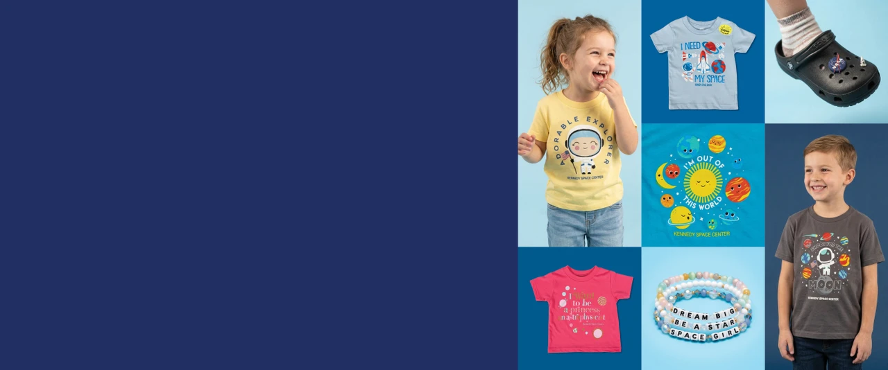 Little girl in yellow astronaut tee and little boy in grey astronaut tee surrounded by other kids tees, bracelets, and a black shoe with charms.