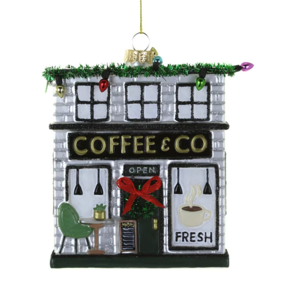 Glass coffee shop ornament with storefront, wreath, red bow, and colorful holiday lights.
Hanging café Christmas ornament with “COFFEE & CO” sign and fresh coffee window graphic.
Coffee Shop glass ornament, 3.75 x 1.25 x 4 inches.