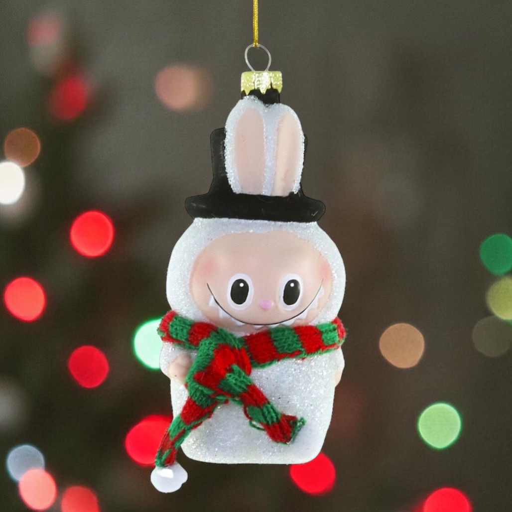Glass Fuzzy Monster Snowman ornament with black top hat and red-and-green scarf.
White hanging character ornament with tall ears, smiling face, and snowy glitter finish.
Fuzzy Monster Snowman glass ornament, 2 x 1.5 x 4.5 inches.
