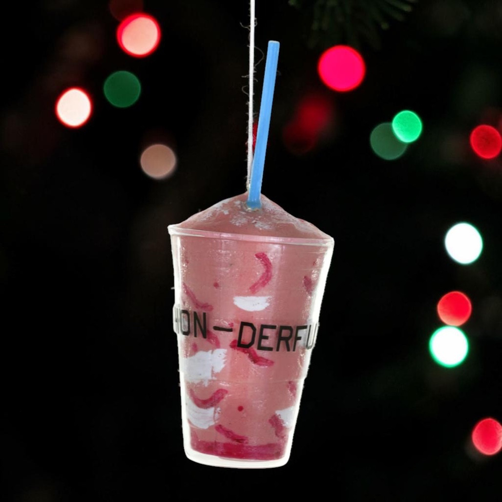 Glass strawberry smoothie ornament with pink drink, clear cup, red fruit details, and blue straw.
Food-themed Christmas ornament shaped like a tall smoothie cup with hanging cord.
LA Strawberry Smoothie glass ornament measuring 2.75 x 2.75 x 6.5 inches.