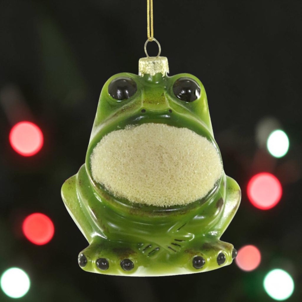Glass kitchen frog sponge ornament with green frog body, black eyes, and textured sponge belly.
Playful frog Christmas ornament hanging from a gold cord with glossy glass finish.
Kitchen Frog Sponge glass ornament measuring 2.75 x 3 x 3.5 inches.