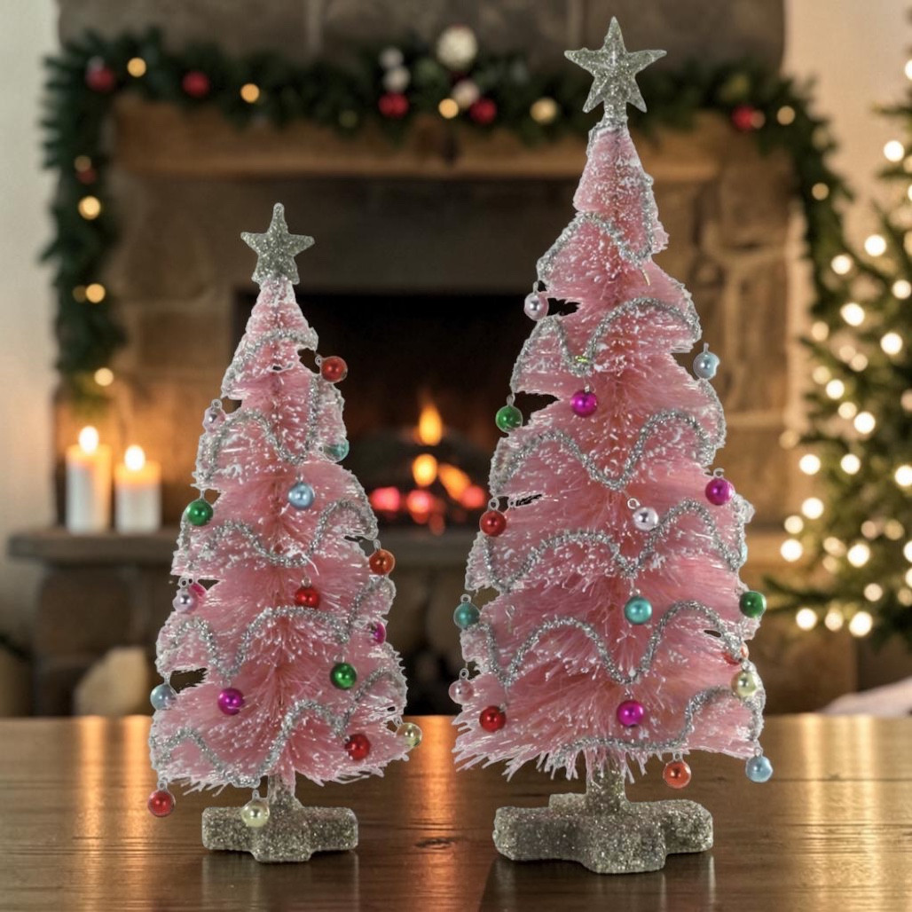 Set of two pink vintage fiber tabletop Christmas trees with silver garland and colorful mini ornaments.
Pink bottle brush-style trees with glittered bases, star toppers, and retro holiday details.
11.5 and 16 inch pink fiber garland tree set for mantel, shelf, or tabletop Christmas décor.