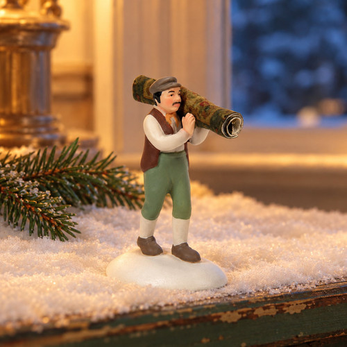 Department 56 Dickens Village - Light As A Drugget – collectible Christmas village piece displayed in a cosy home
