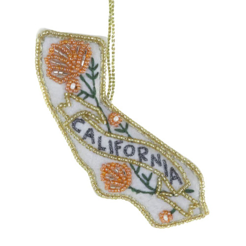 California-shaped ornament with white background, gold trim, orange flowers, and CALIFORNIA banner.
Close-up of embroidered-style California ornament with floral accents and hanging gold cord.
3.75 × 1 × 4.25 inch sequin California ornament with gold edging and decorative banner.