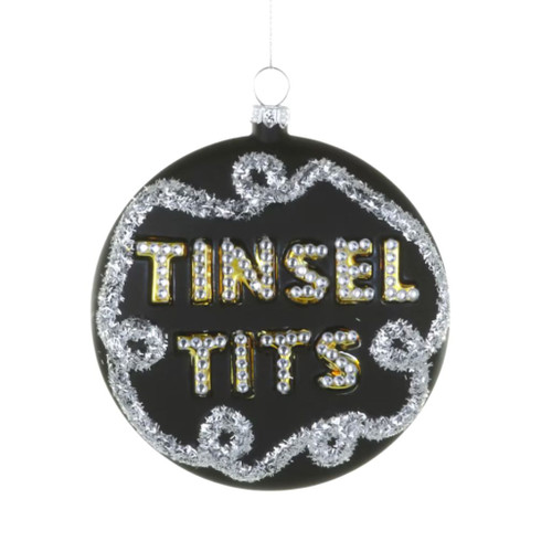Black glass ornament with Tinsel Tits lettering and silver tinsel-style border.
Round black Christmas ornament with raised silver lettering and glittery details.
Hanging glass statement ornament measuring 4 × 1 × 4 inches.
