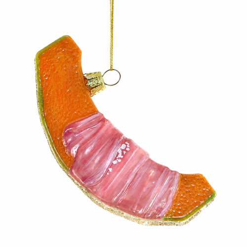 Glass Christmas ornament shaped like prosciutto wrapped melon with orange, pink, and green details.
Curved melon slice ornament with glossy pink prosciutto wrapping and glittered edge.
4 inch glass food ornament depicting prosciutto wrapped melon with hanging cord.