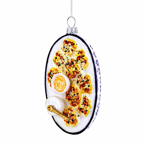 Glass latkes ornament shaped like a serving platter with golden latkes and dipping bowls.
Food-themed hanging ornament with white platter, black rim, and silver cap.
Latkes glass ornament measuring 2.5 x 2 x 4.5 inches.