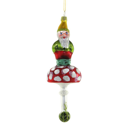 Forest gnome glass Christmas ornament sitting on a red-and-white spotted mushroom.
Woodland gnome ornament with green outfit, golden hat, glitter accents, and hanging cord.
2 x 2 x 6 inch glass gnome ornament for Christmas tree or woodland holiday décor.